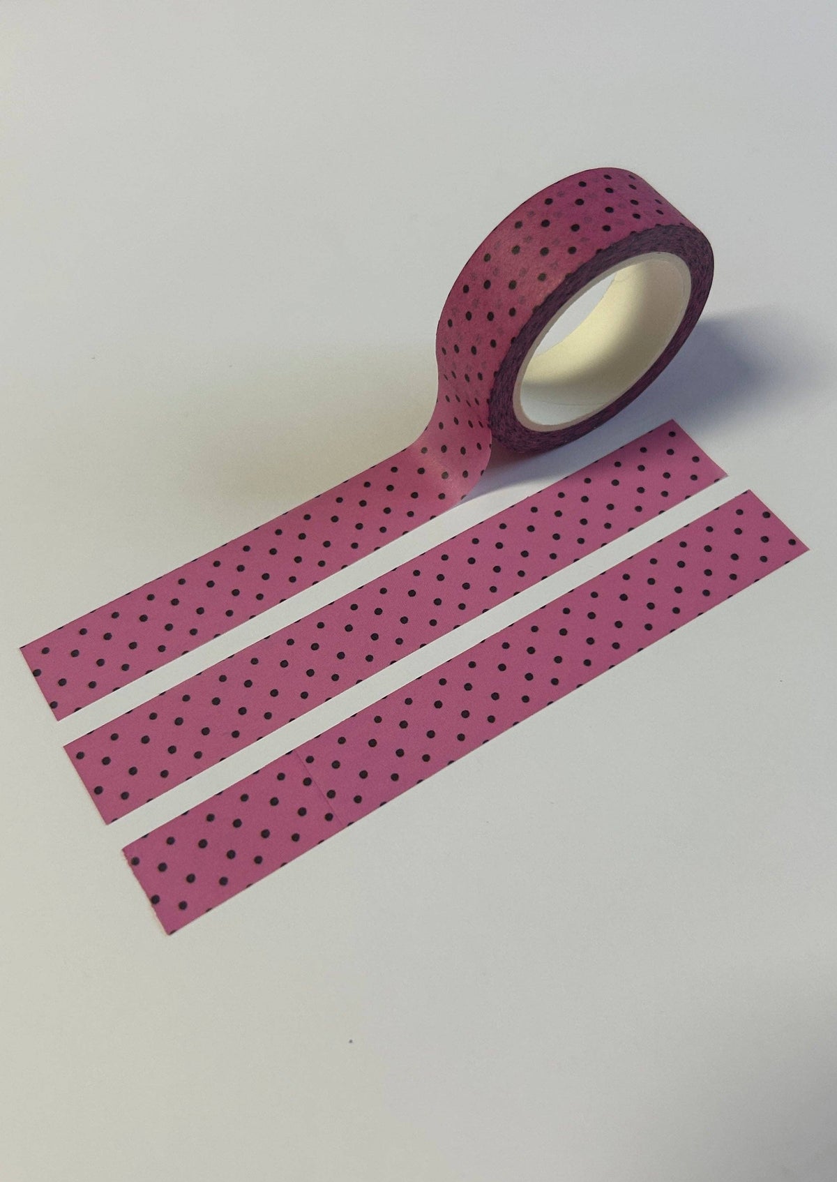 Pink polka dot washi tape strips with black dots and rolled end