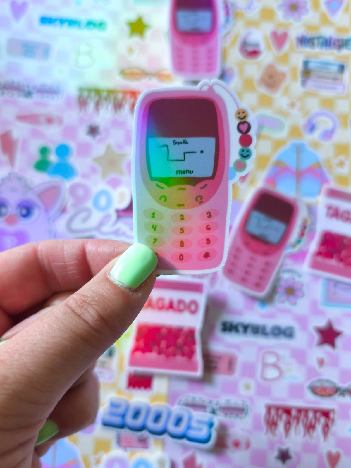 Pink phone sticker held in hand, showing keypad and character icons