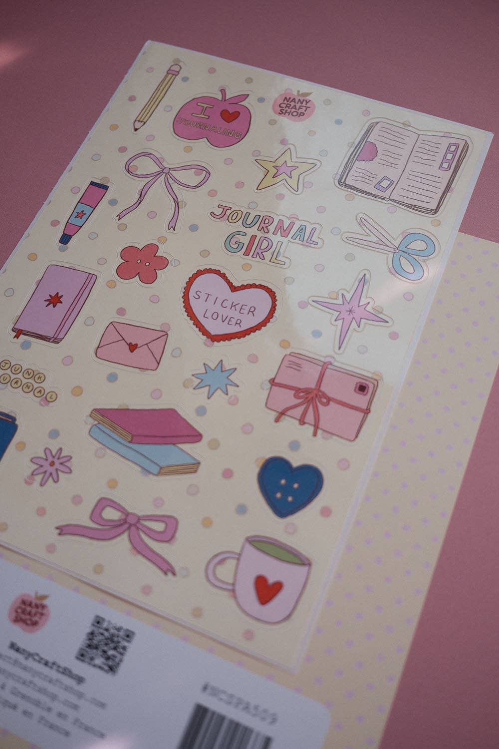 A5 sticker sheet featuring stationery, hearts, stars, bows and gift icons in pink and blue
