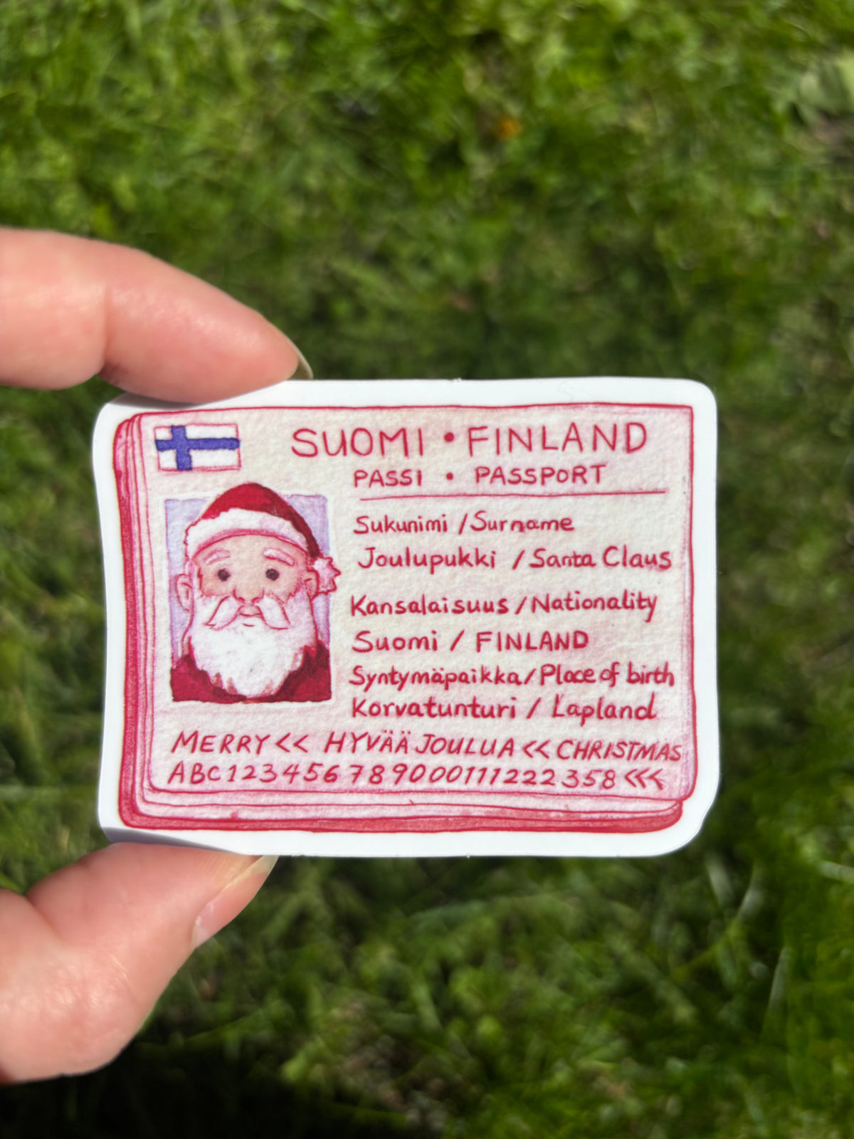Passport-style Suomi Finland vinyl sticker with Santa illustration and text