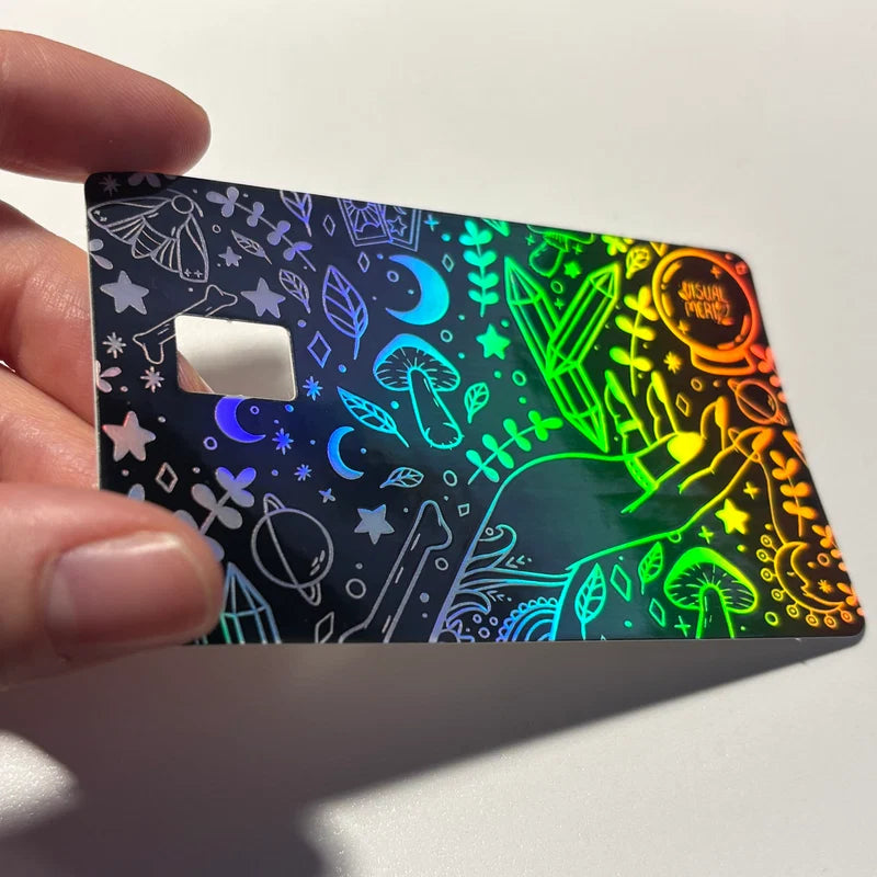Credit card sticker with neon green, blue, yellow space icons on dark base