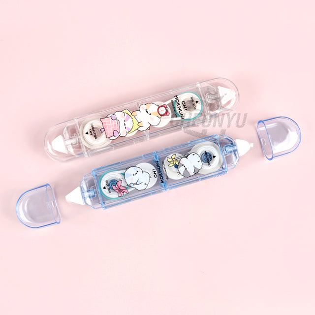 Correction tape and glue tape pair in clear dispensers with cute cartoon prints.