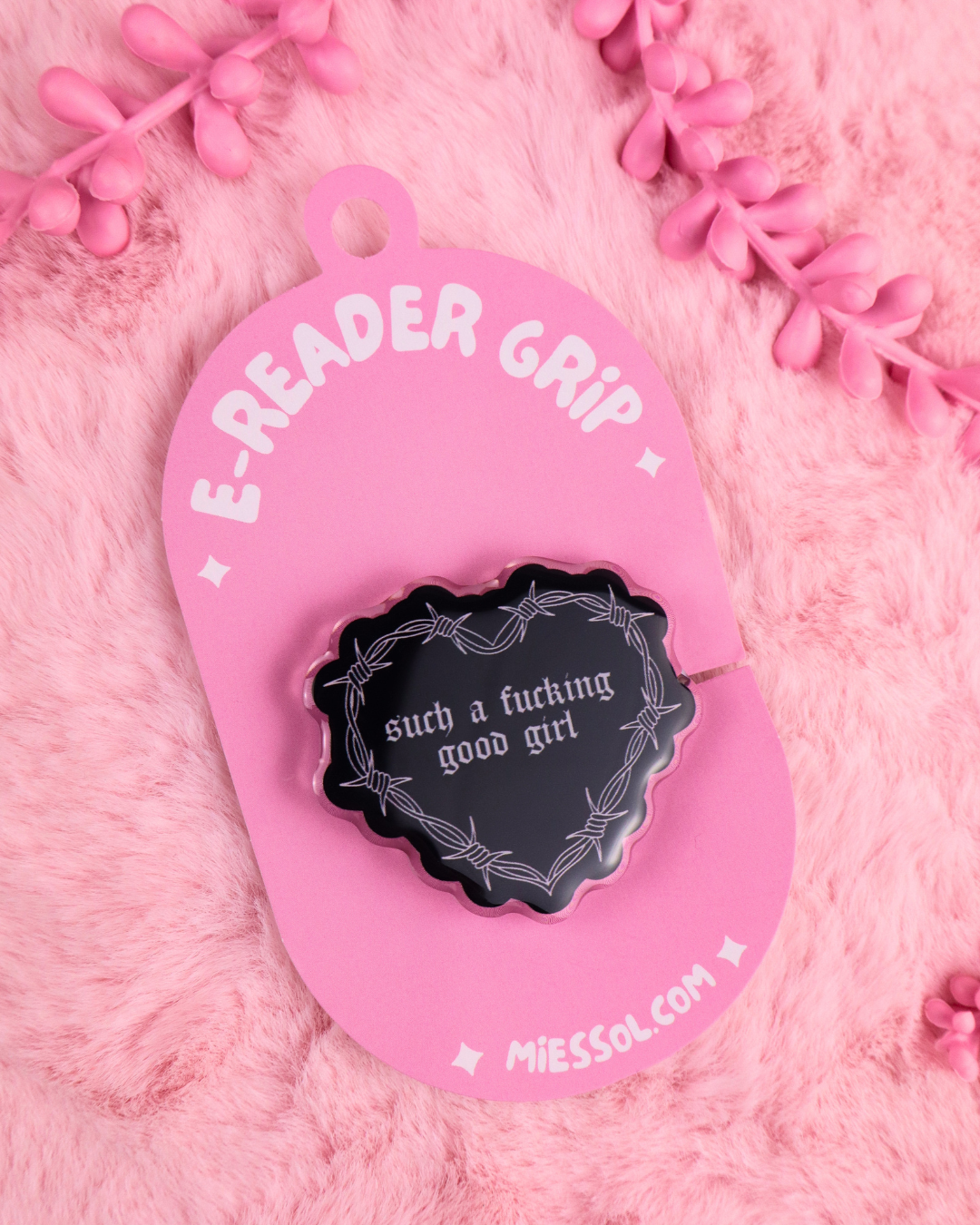 Pink e-reader grip tag with black emblem: “such a f*cking good girl”