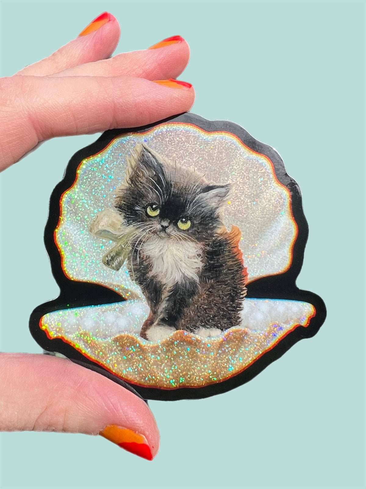 3-inch tuxedo cat in seashell sticker with glittery iridescent edges