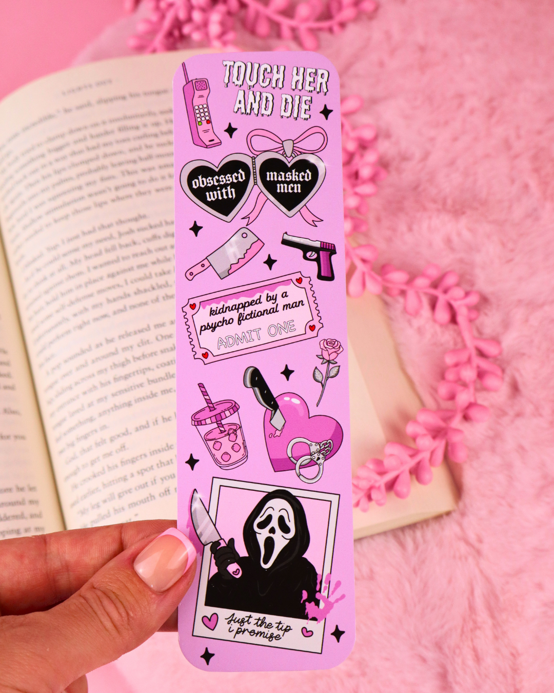 Purple illustrated bookmark with skull figure at the bottom and gothic icons