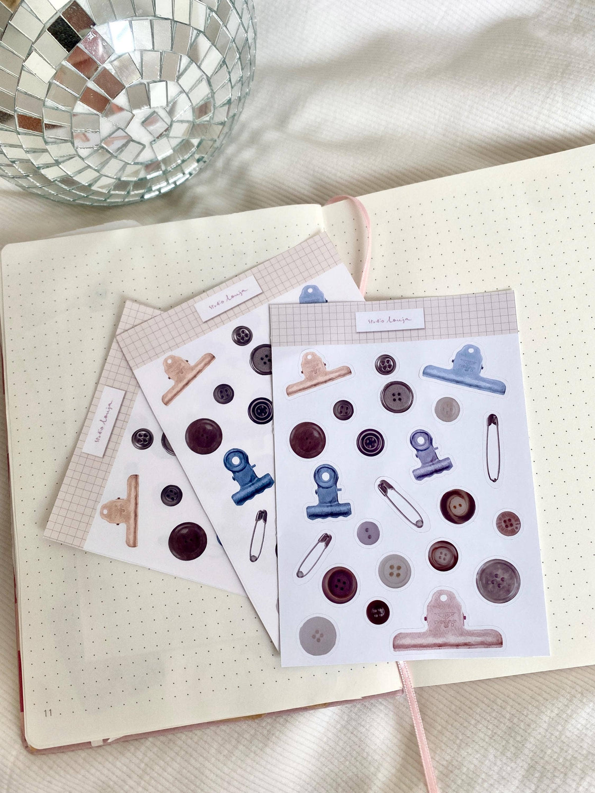 Three button-themed sticker sheets with sewing icons and round button designs