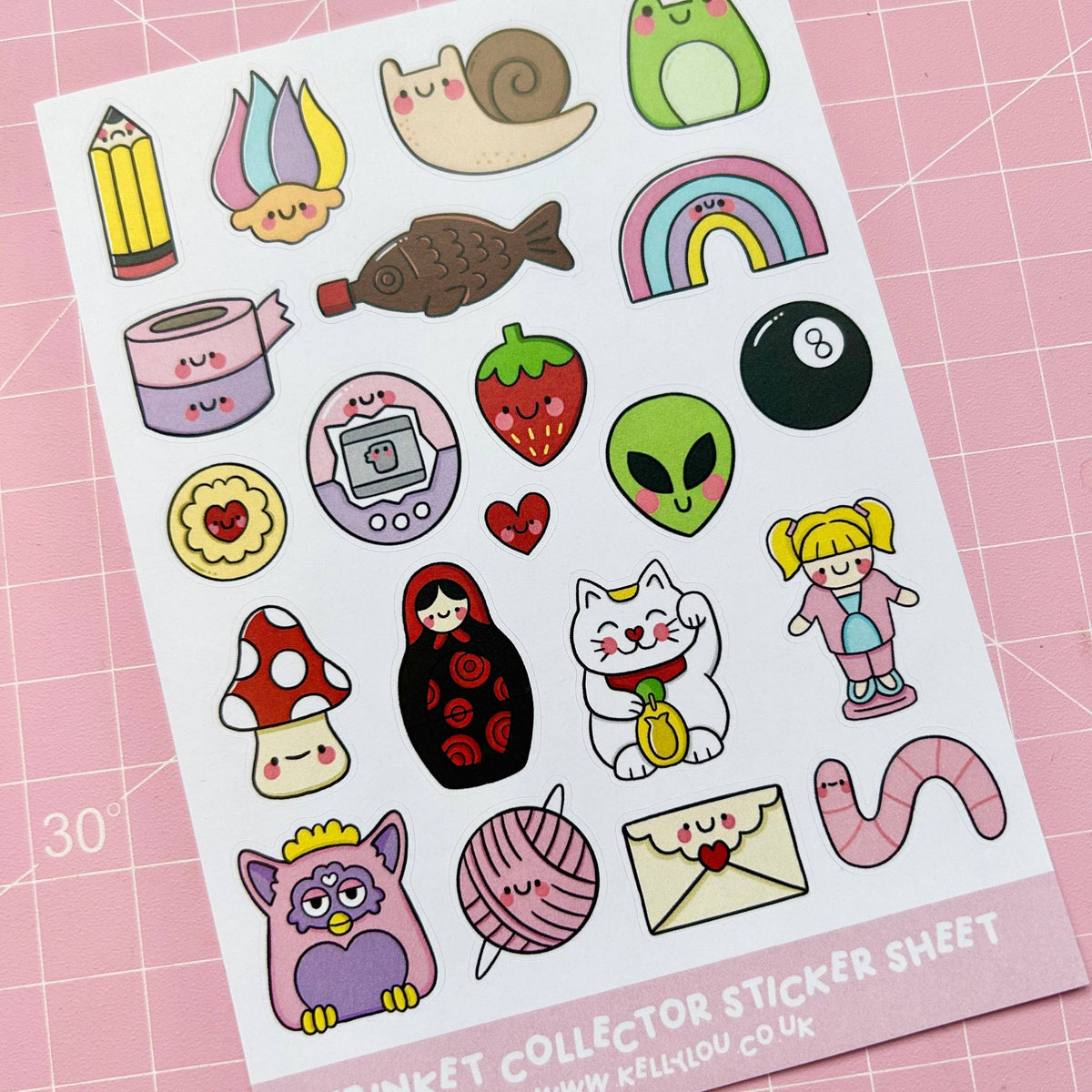 Deco sticker sheet with cute animals, rainbows, candies, and envelopes on white backing