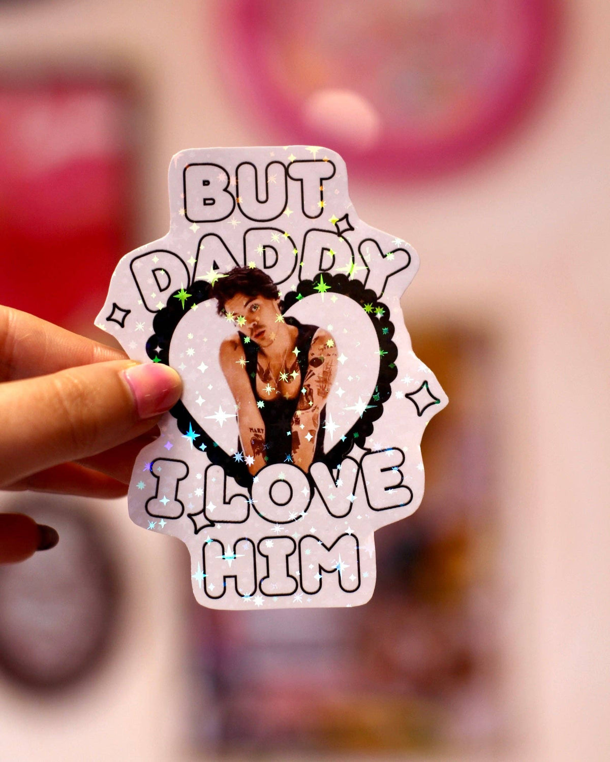Holographic sticker reading 'BUT DADDY I LOVE HIM' with heart photo of Harry Styles