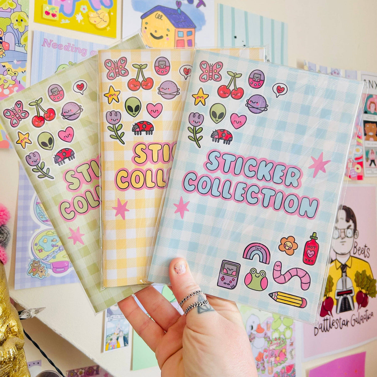 Blue reusable sticker book with cartoon icons, cherries, butterflies, and Sticker Collection cover