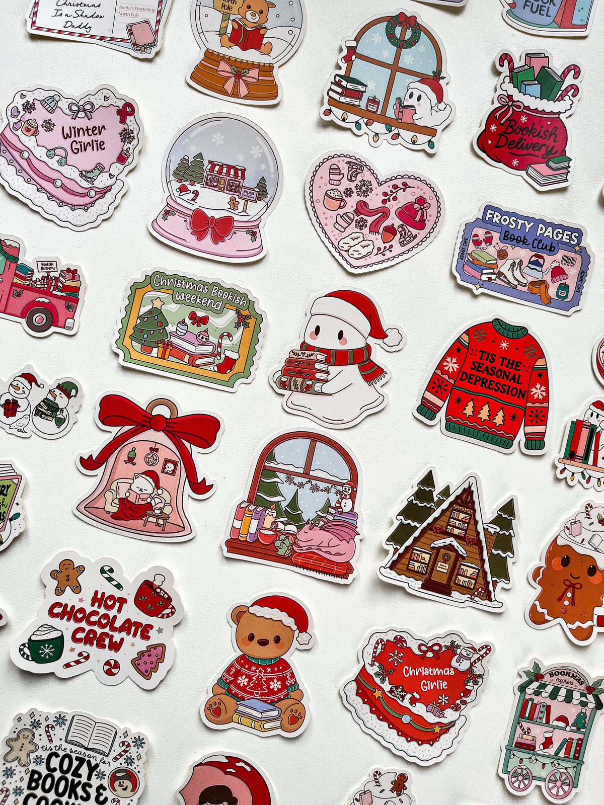 Assorted Santa and Christmas vinyl stickers with red, green, and white designs on white backing