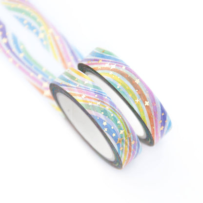 Washi tape rolls with pastel rainbow stripes and small star confetti, two rolls