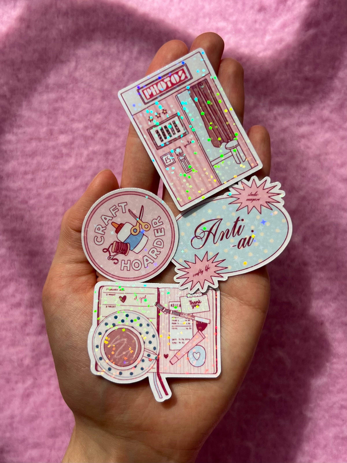 Holographic anti-AI sticker set held in hand, oval and round designs with graphics