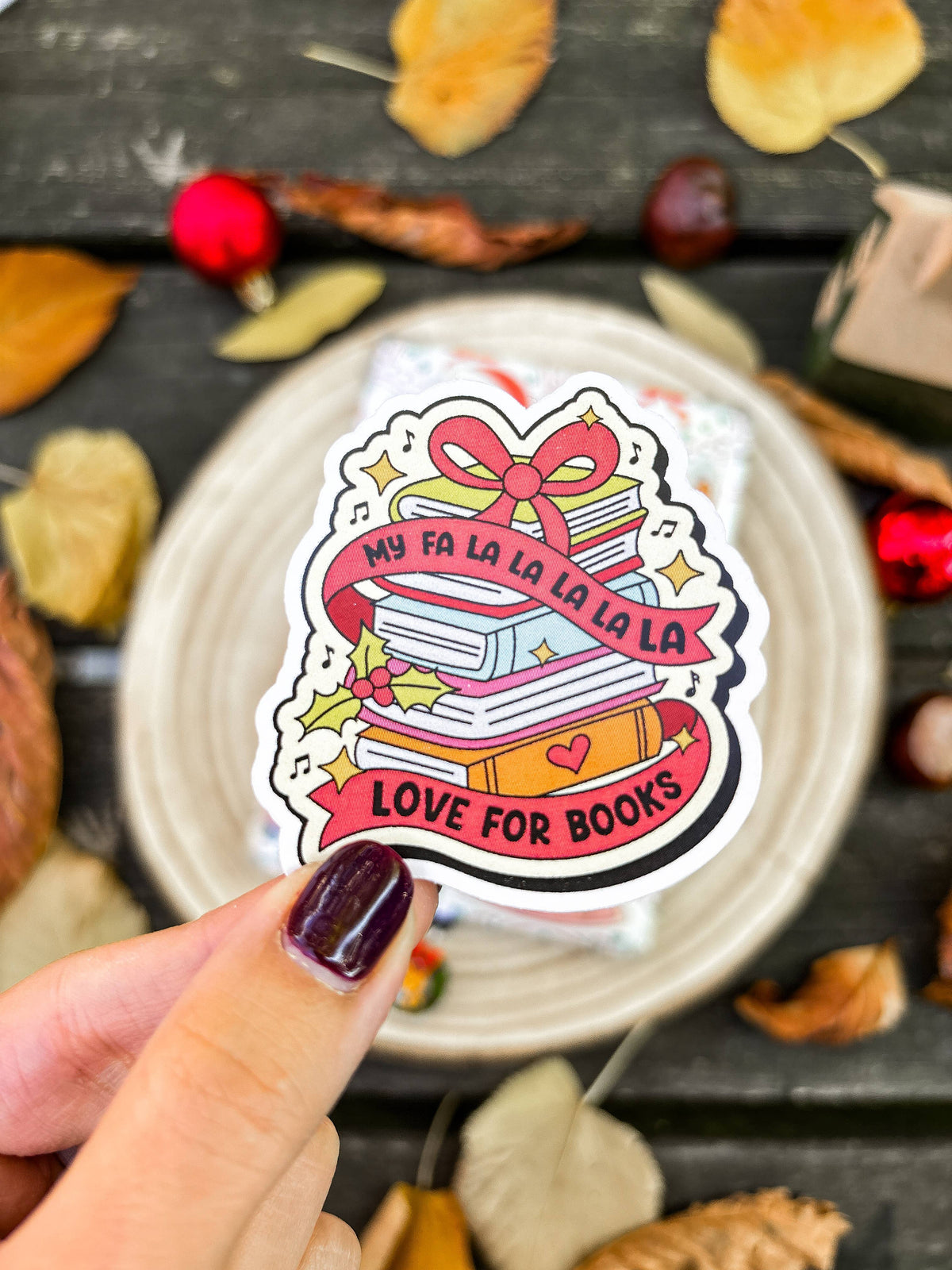 Christmas book-themed vinyl sticker with pink ribbon "Love for Books" design