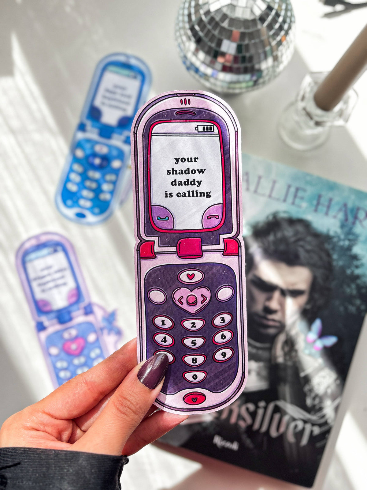 Pink and purple phone-shaped bookmark with message "your shadow daddy is calling".
