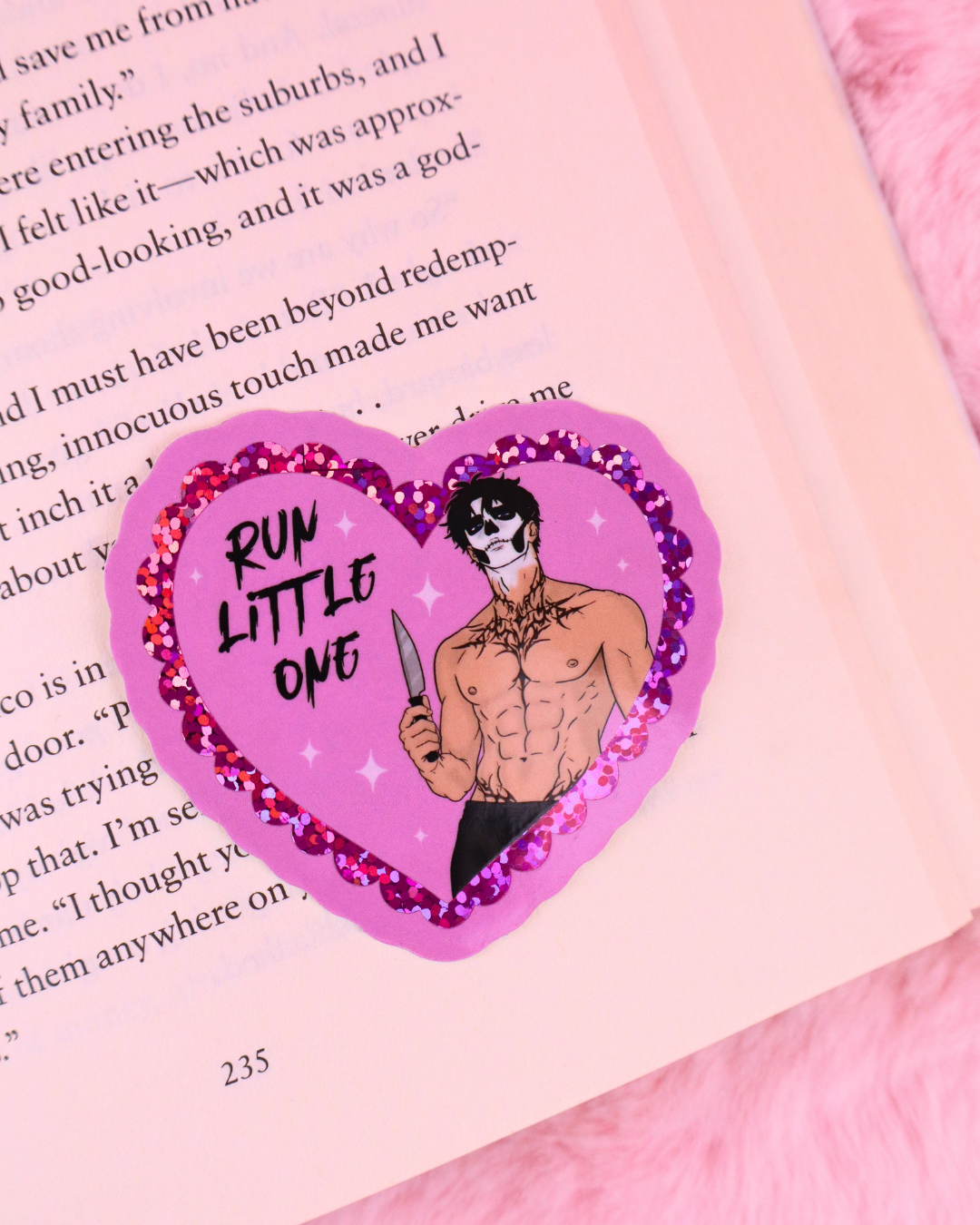 Heart-shaped vinyl glitter sticker on page with 'RUN LITTLE ONE' character