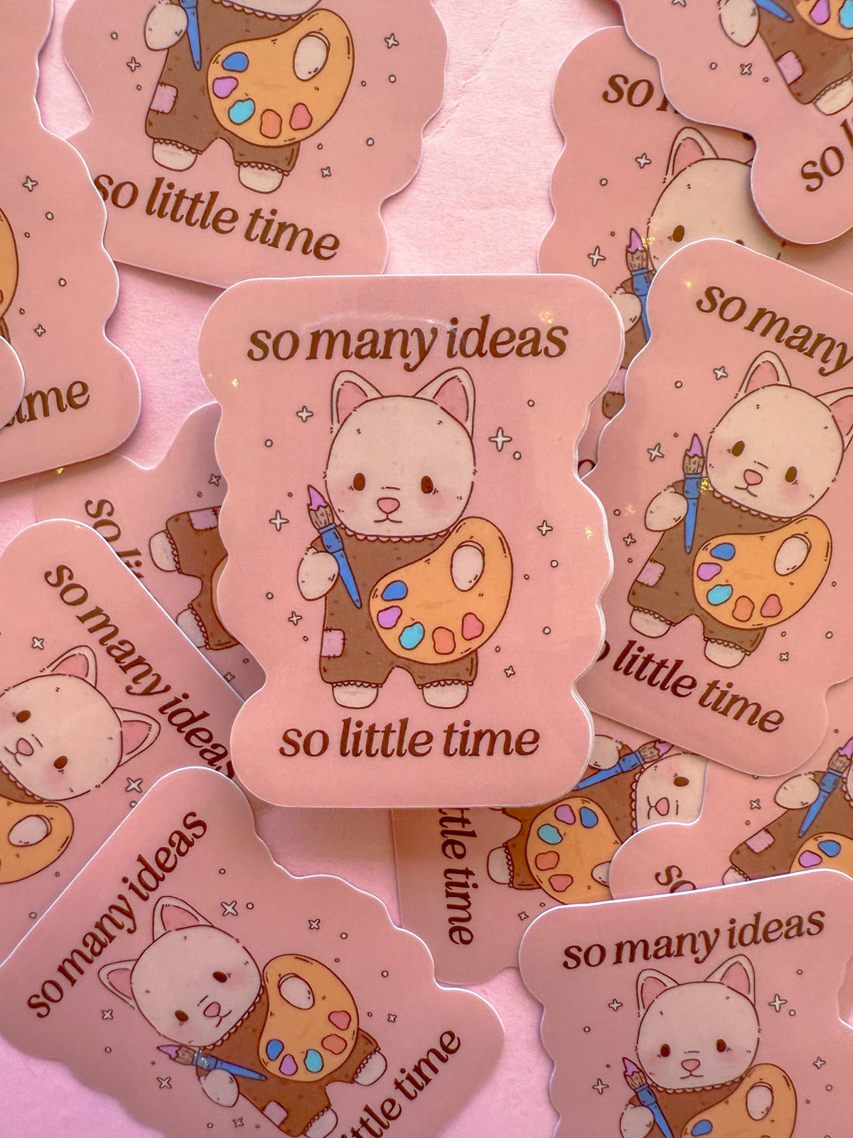 So Many Ideas vinyl stickers showing pink cat with art palette, repeating 'so little time'
