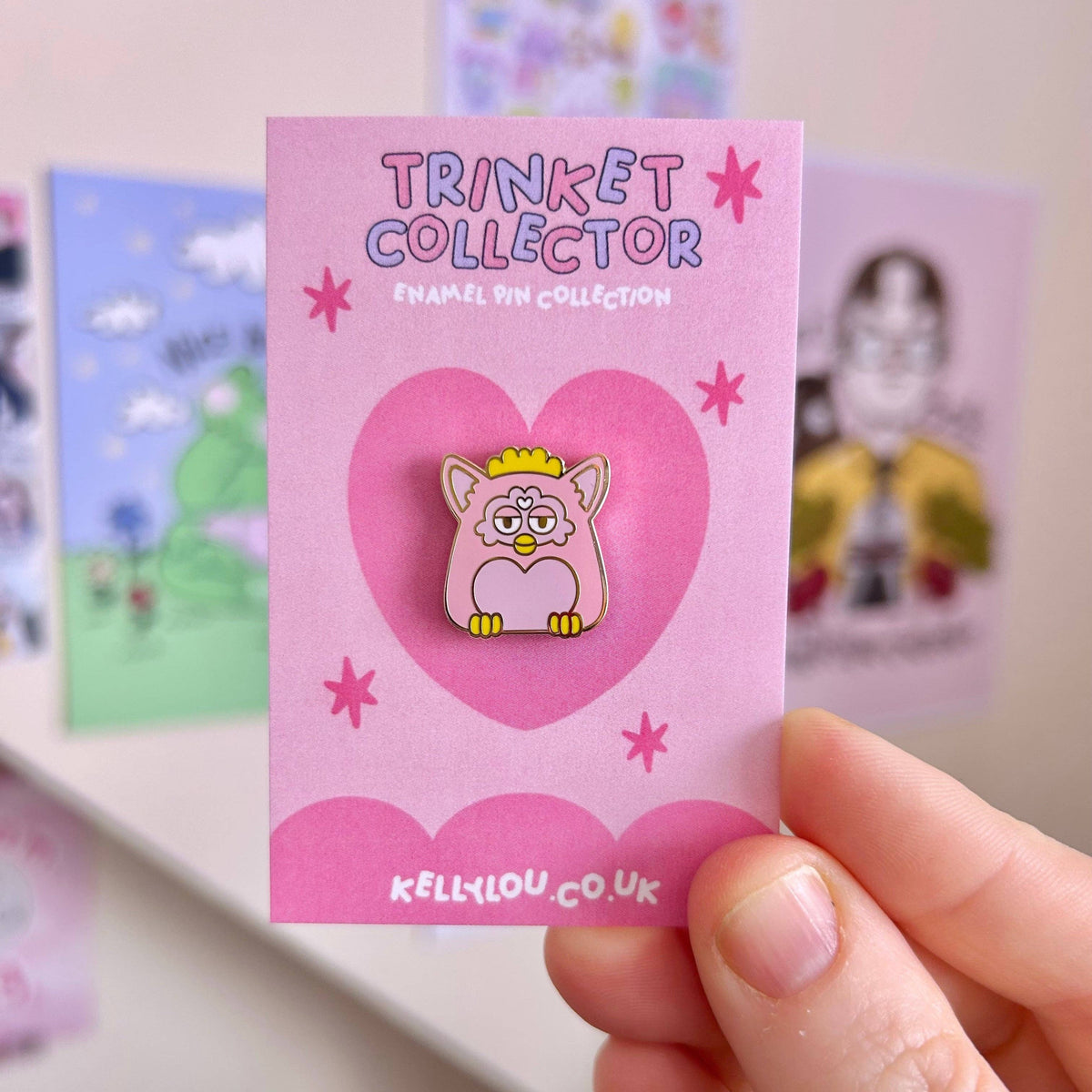 Grey cartoon cat enamel pin with yellow crown on collector card