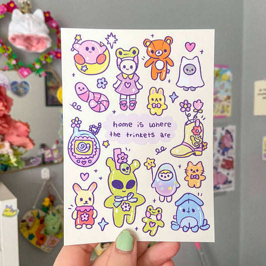 Cute A6 illustration print with colorful characters and text 'home is where the trinkets are'