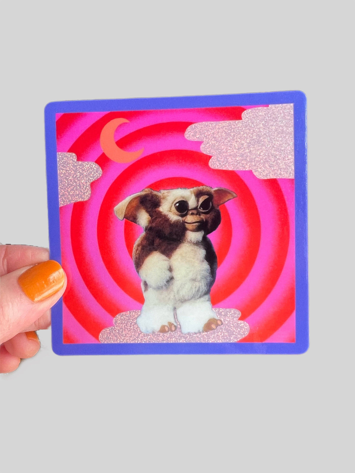Square Mogwai sticker with glittery finish, blue outline, cartoon dog in red ring
