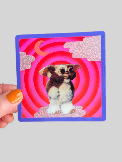 Square Mogwai sticker with glittery finish, blue outline, cartoon dog in red ring