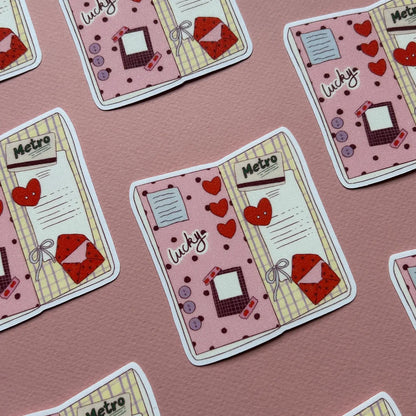 Booklet-shaped sticker set with Metro label, hearts, lined notes, and red envelopes
