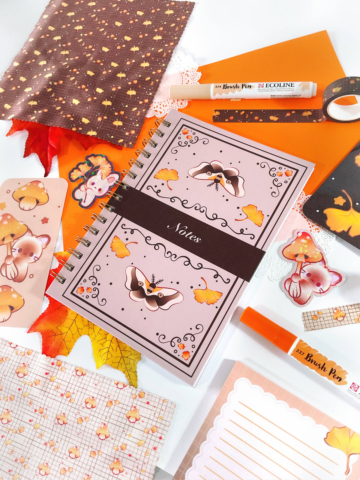 Spiral notebook with framed animal illustrations on the orange cover