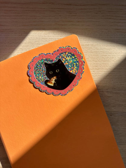 Orange-backed vinyl glitter sticker card with black cat in scalloped heart