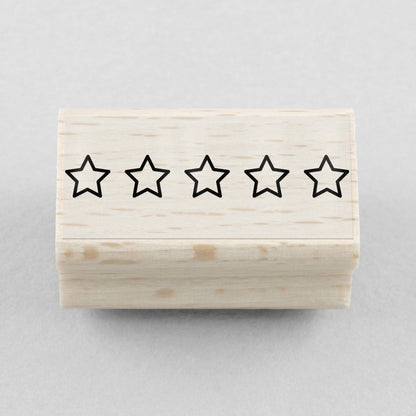 Wooden stamp block with five black star outlines, rating mark stamp