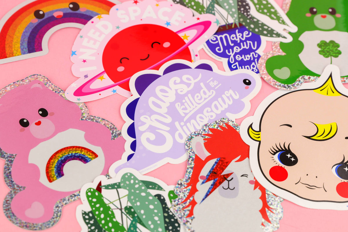 Partial view glitter care bear sticker with rainbow and hearts among other designs