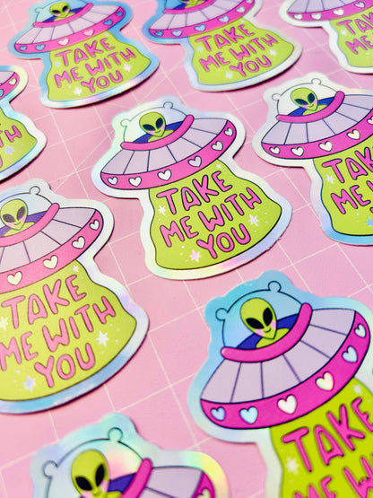 Holographic UFO stickers: lime alien heads in purple saucers with heart accents and text.