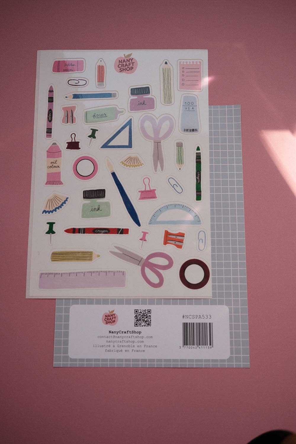 A5 sticker sheet with illustrated office supplies, pens, scissors, and rulers