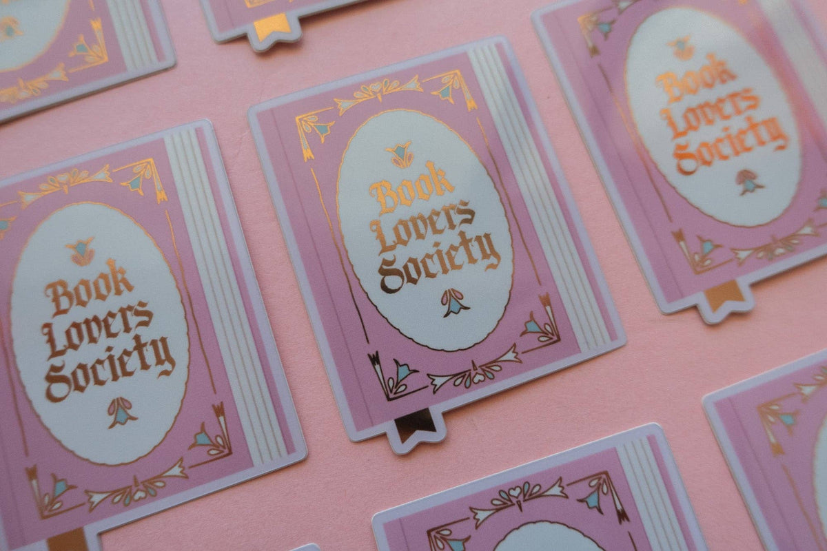 Vinyl sticker assortment with oval “Book Lovers Society” center and purple gold-trim frame