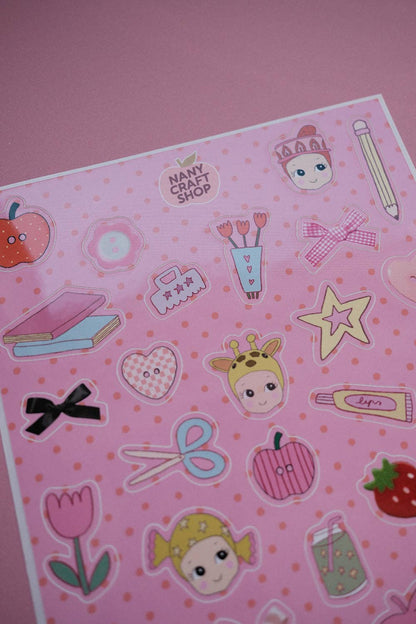 Pink sticker sheet with character faces, stars, hearts, and school stationery shapes