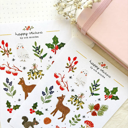 Winter nature sticker sheet close-up with birds, deer, holly leaves, and berry branches