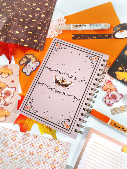 Open spiral notebook with animal illustration cover and lined notes pages