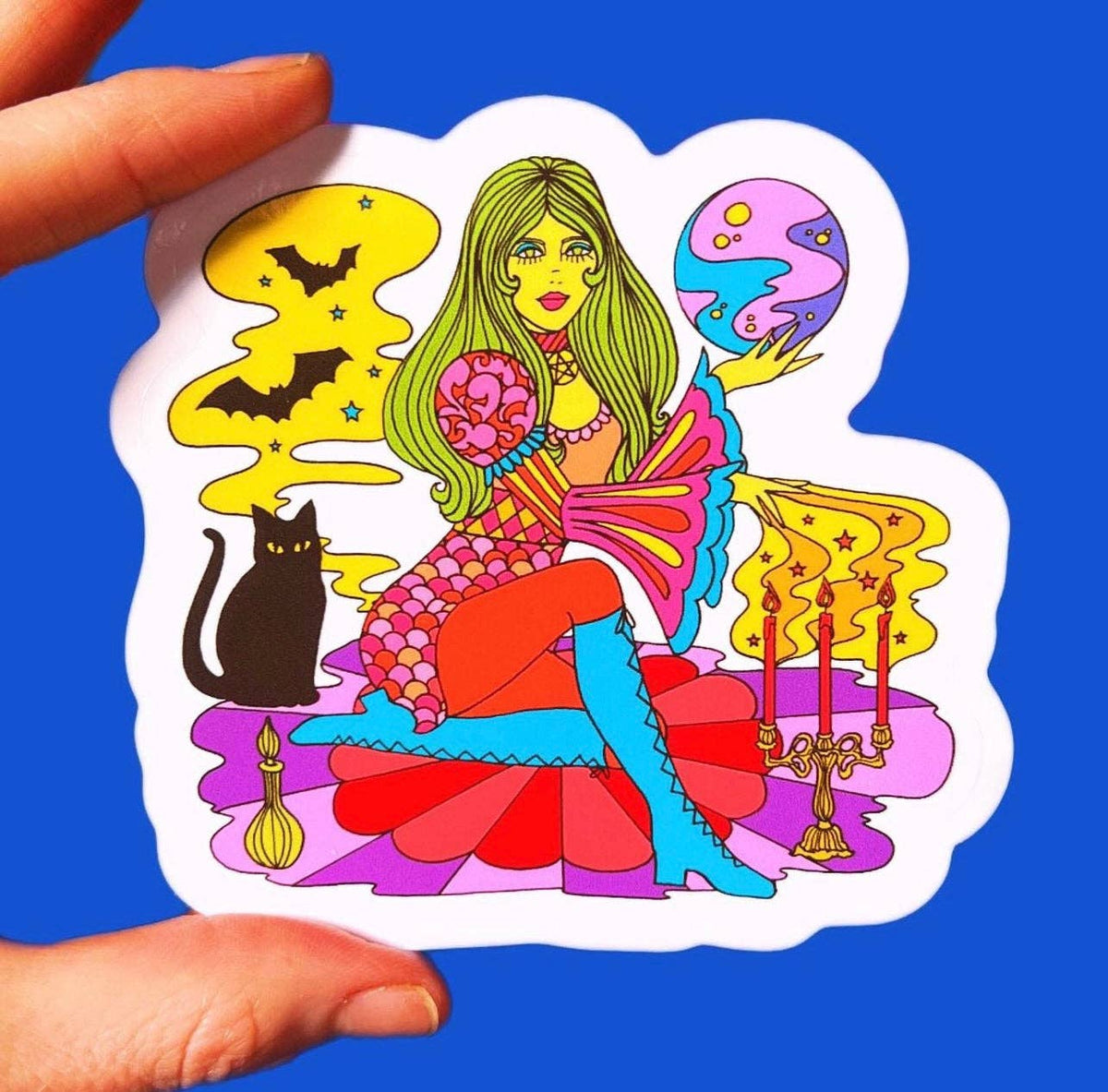 Colorful witch and cat tarot sticker with white border, held by hand