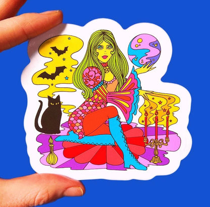 Colorful witch and cat tarot sticker with white border, held by hand