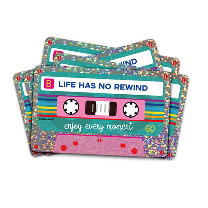 Glitter vinyl cassette sticker showing 'Life has no rewind' with multicolor bands.