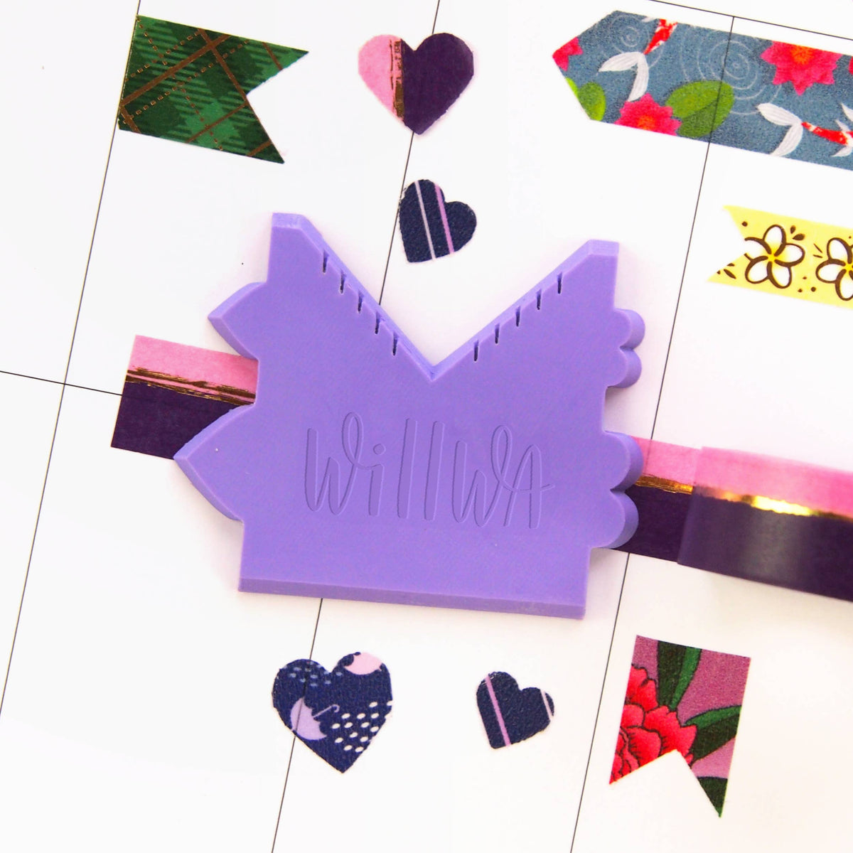 Purple washi cutter shaped like a house with decorative edge notches and “WILWIA” embossing
