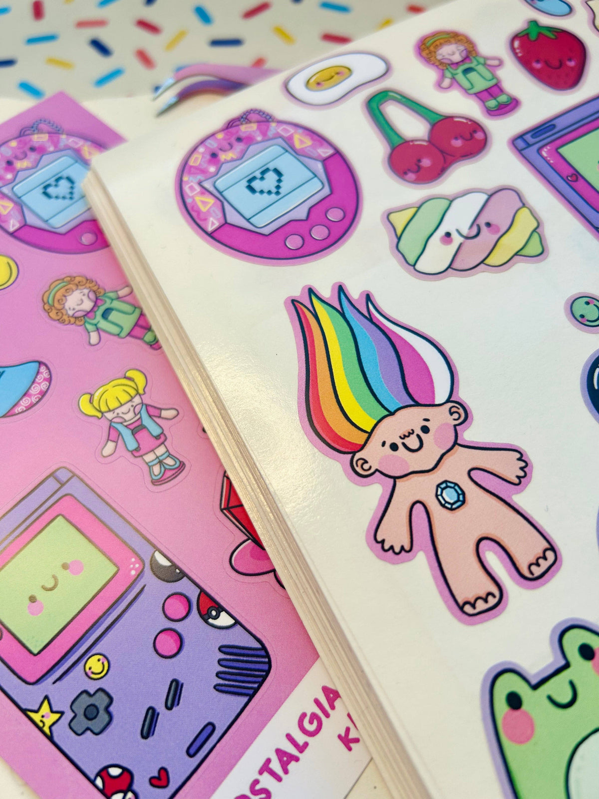 Vinyl sticker sheet page featuring rainbow bunny, gaming icons, and character decals