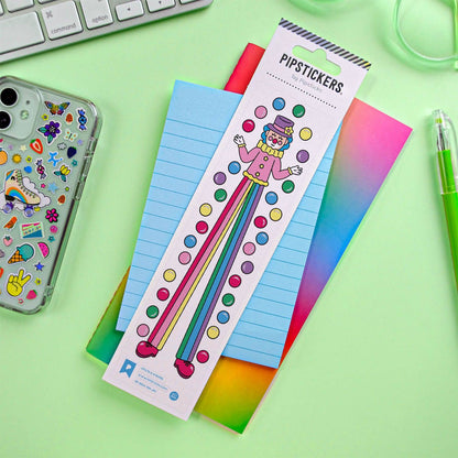 Sticker sheet featuring cartoon striped character with multicolor dots, on blue notebook