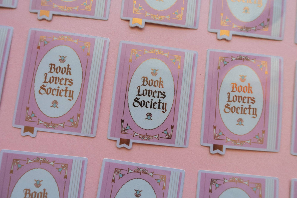 Vinyl sticker designs in rows, each with purple frame and oval “Book Lovers Society”