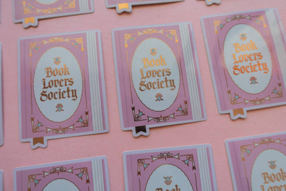 Vinyl sticker cards with purple-framed ovals reading “Book Lovers Society”