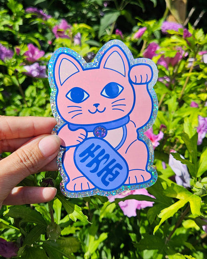 Glitter vinyl lucky cat sticker held in hand, pink cat with blue fortune coin