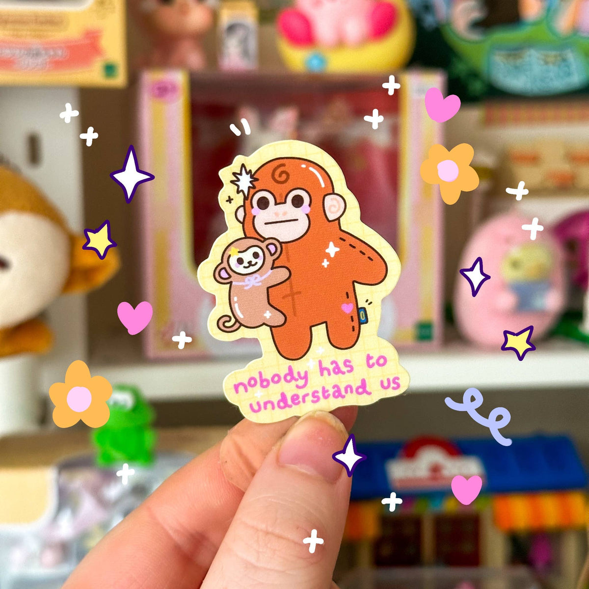 Mini cartoon monkey sticker with bear, hearts and stars, outlined badge style