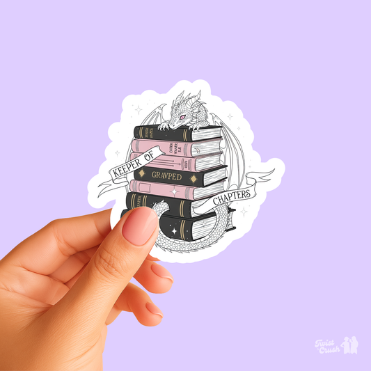 Book lover sticker with dragon and stacked books on circular white backing