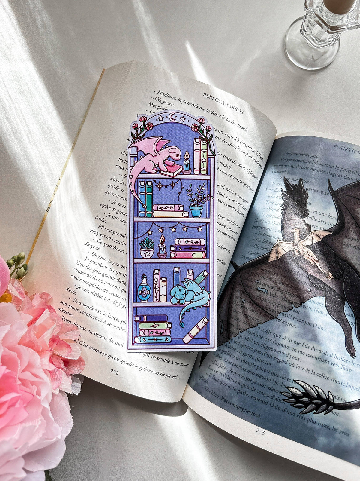 Fantasy bookmark showing a purple catlike creature among stacked books