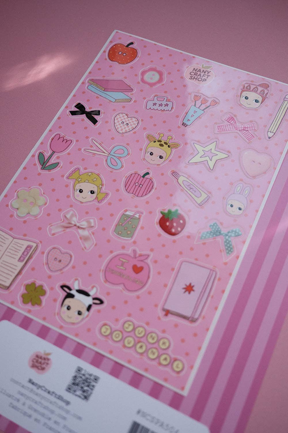 Pink sticker sheet with characters, strawberries, hearts, and colorful outline icons