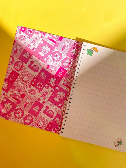 Open spiral notebook with pink patterned left page and lined right page