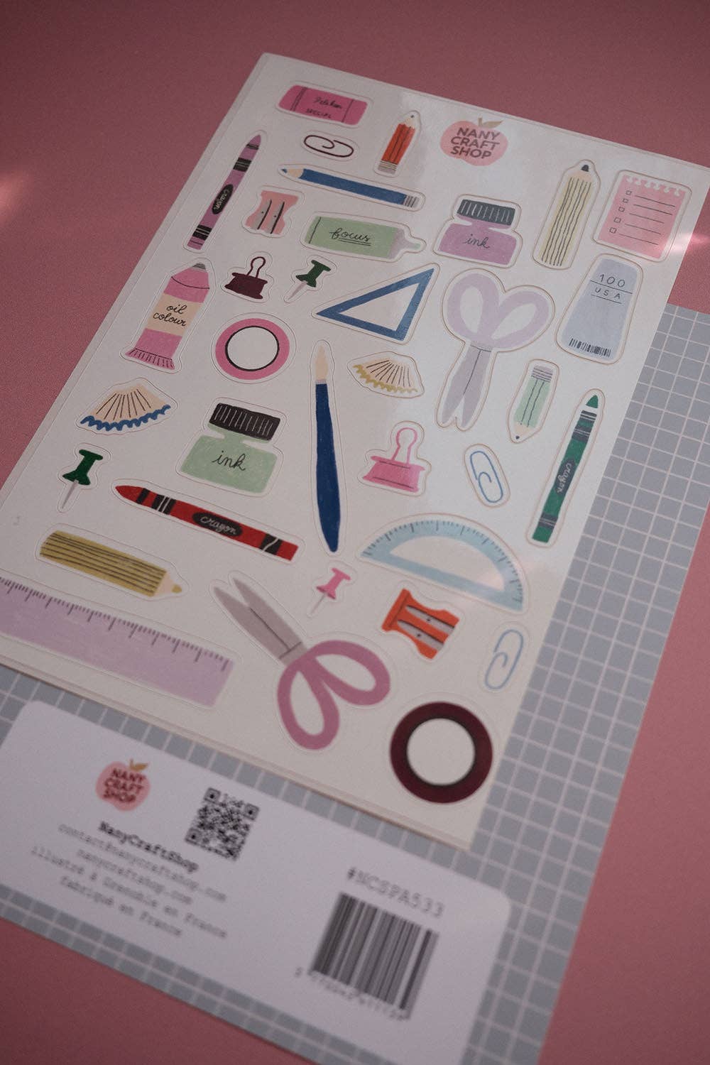 A5 sticker sheet featuring colorful school and craft stickers, rulers, pens, and paper clips